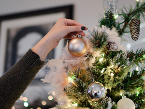 Person-decorating-christmas-tree