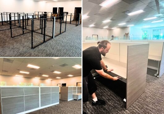 Professional office furniture installation team setting up workstations